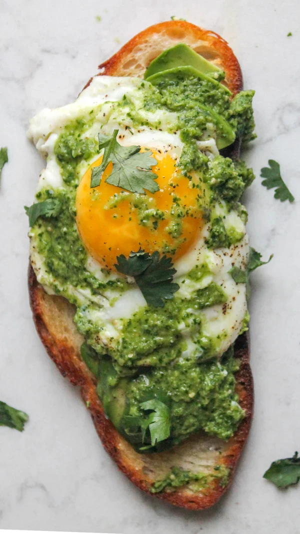 Avocado toast with a fried egg and tomatillo salsa verde with hot pepper sardines